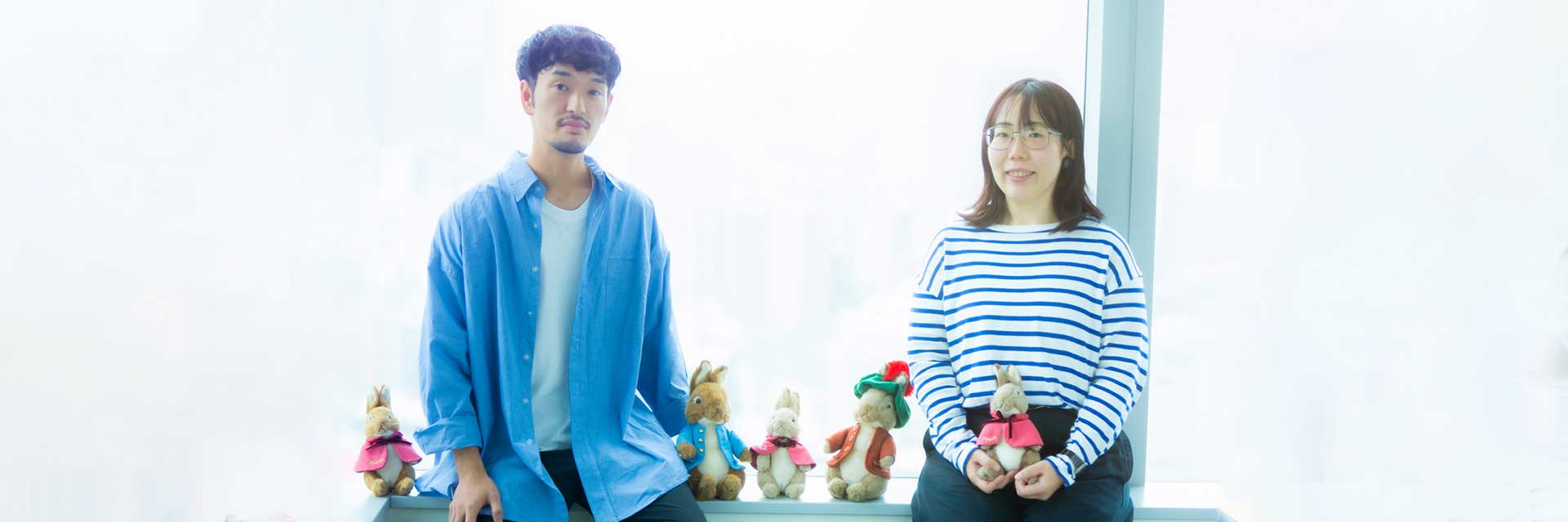 Kenji and Eri in photo with Peter Rabbit stuffed animals
