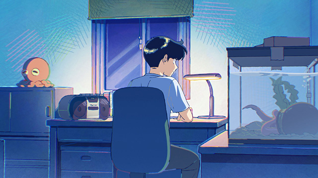 机に座る中村くん